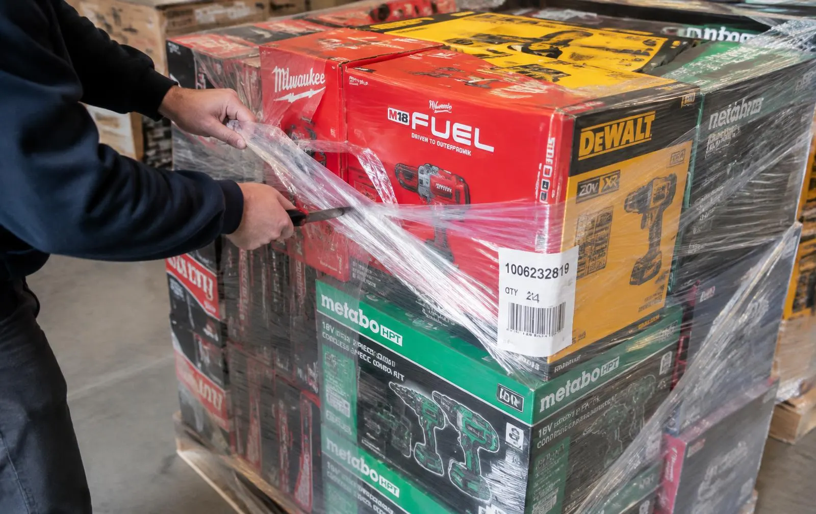 A person unboxing a new pallet of Milwaukee tools, showing the fresh state of Milwaukee overstock pallets